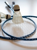 Image of badminton rackets and shuttle cocks on a floor