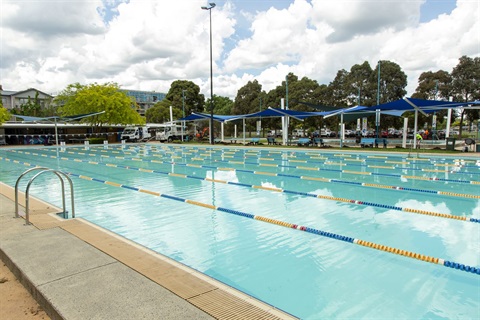 Looking at the Croydon Memorial Pool from the north end with a pool ladder in the foreground