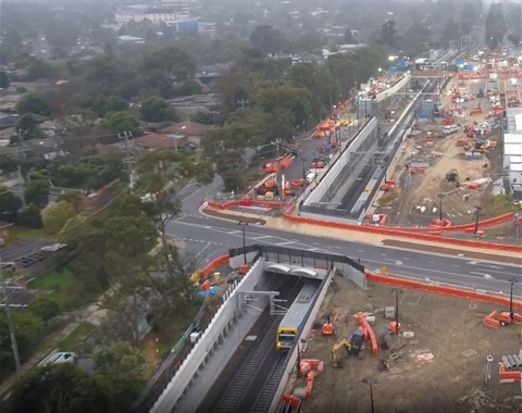 Birds eye view of a train running underneath Dublin Road after the road has reopened